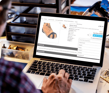 Man with his hand on a laptop trackpad browsing an eCommerce store.