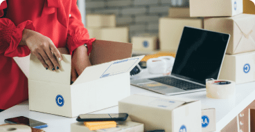 Person filling up a package, fulfilling an eCommerce order.