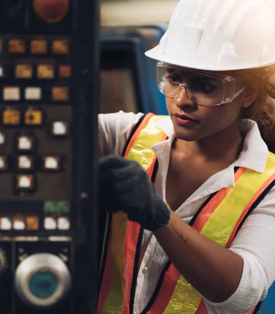 A female worker operating a machine.